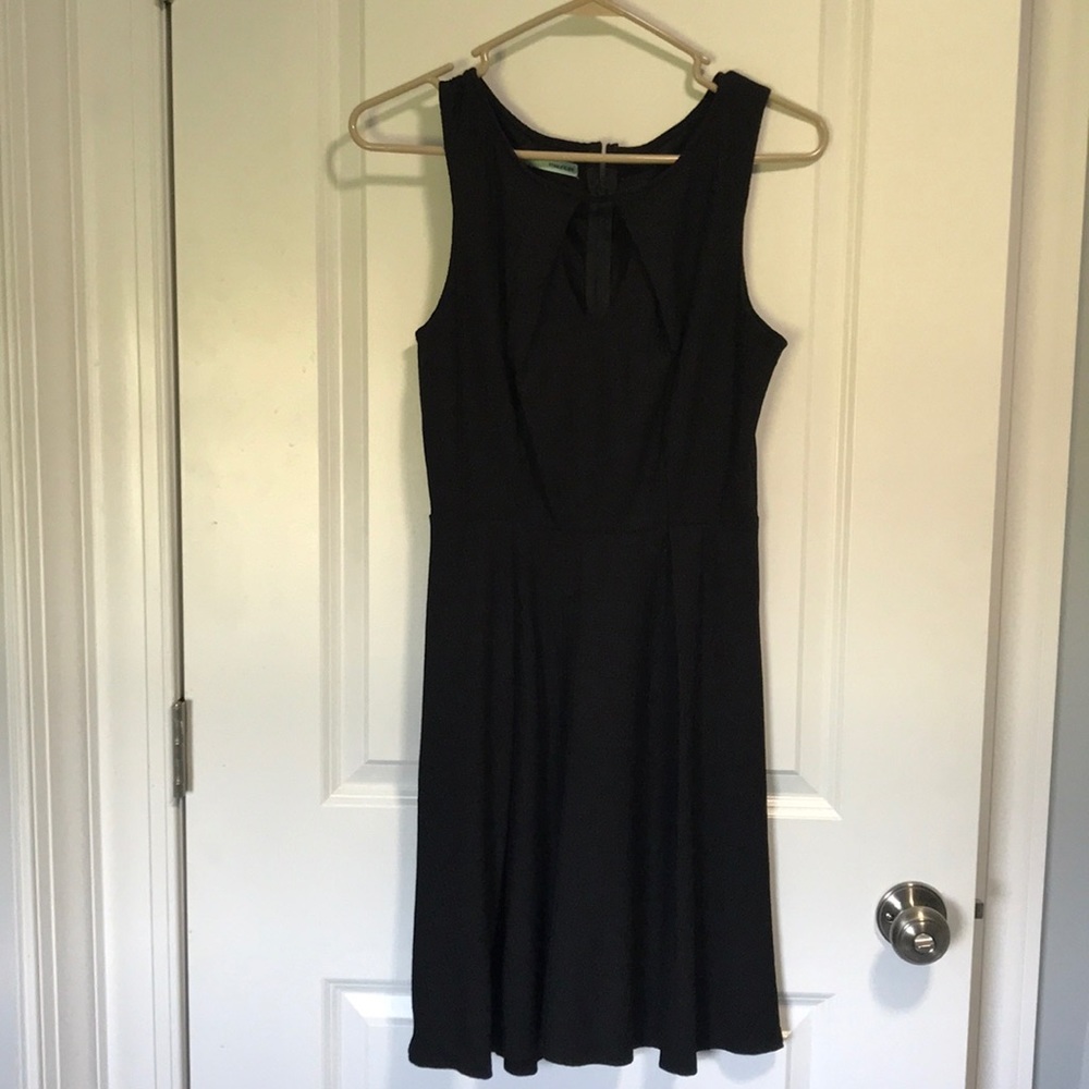 Black sleeveless dress with keyhole cut out.